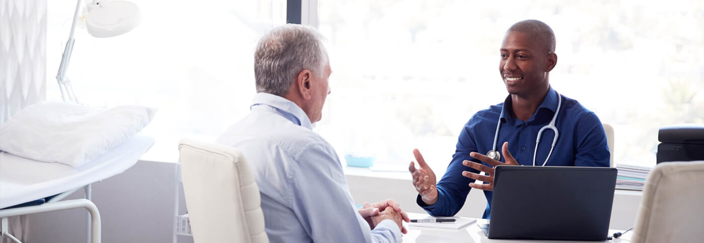 patient speaking with doctor in office